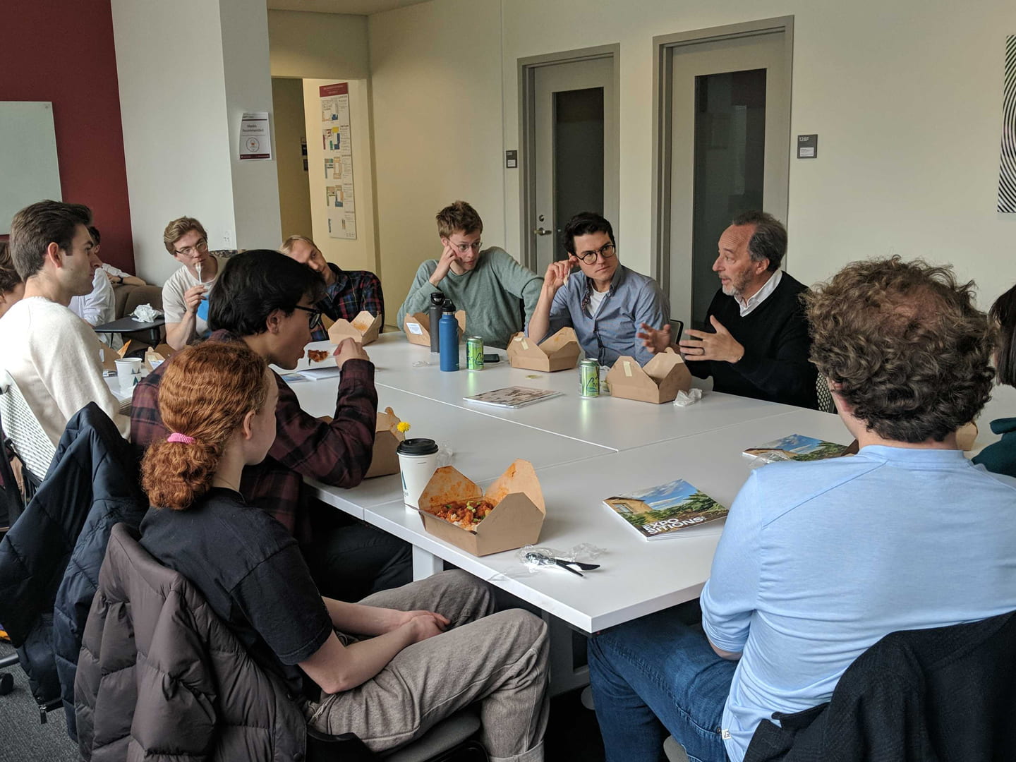 Michael Kimmelman speaking to a group of students around a large table